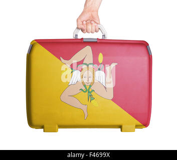 Used plastic suitcase with stains and scratches, printed with flag - Sicily Stock Photo