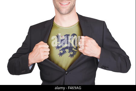 Businessman opening suit to reveal shirt with flag, Flanders Stock Photo