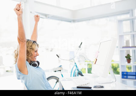 Young smiling businesswoman cheering Stock Photo