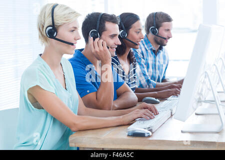 Call centre workers on their laptops Stock Photo
