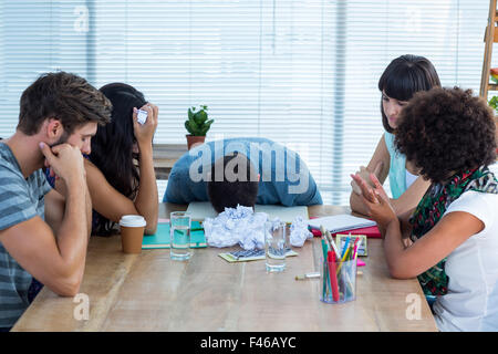 Exhausted creative business team in meeting Stock Photo