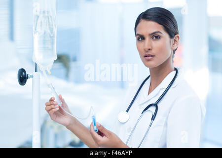 Nurse connecting an intravenous drip Stock Photo