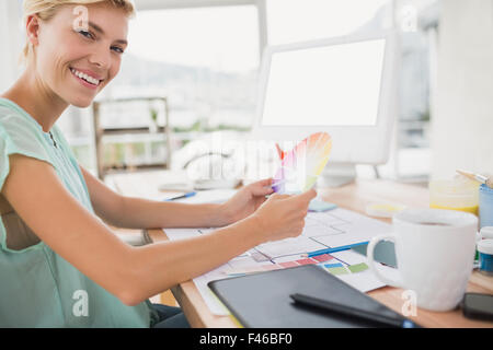 Smiling creative businesswoman looking at the camera Stock Photo