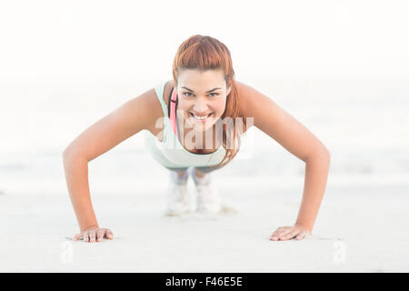 Beautiful brunette doing push ups Stock Photo