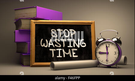 Stop Wasting Time - Motivational Quote on Chalkboard. Stock Photo