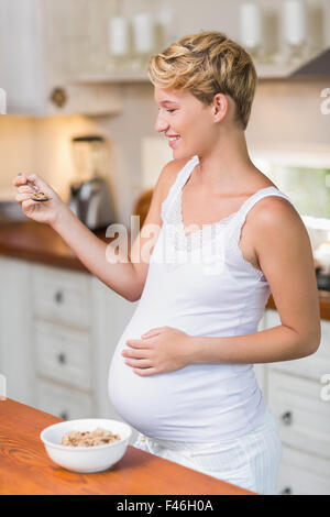 Pregnant woman about to eat cereals Stock Photo