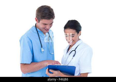 Doctors and nurses discussing over notes Stock Photo