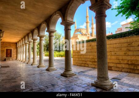 The Mohammad Al-Amin Mosque situated in Downtown Beirut, in Lebanon as viewed through the pillars of the Greek Orthodox church o Stock Photo