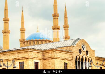 The Mohammad Al-Amin Mosque situated in Downtown Beirut, in Lebanon as viewed rising over the Greek Orthodox church of St George Stock Photo