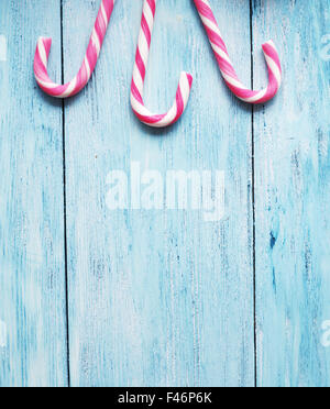 Candy canes on blue wooden background. Stock Photo