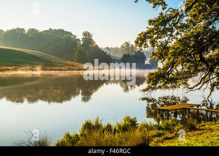 Autumn mist over the lake on the  Bowood Estate in Wiltshire. Stock Photo