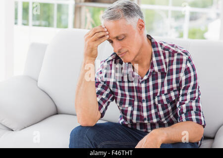 Businessman with severe headache in office Stock Photo