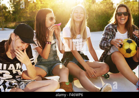 Friends enjoying the summer in a yard, sunflare and summer evening Stock Photo