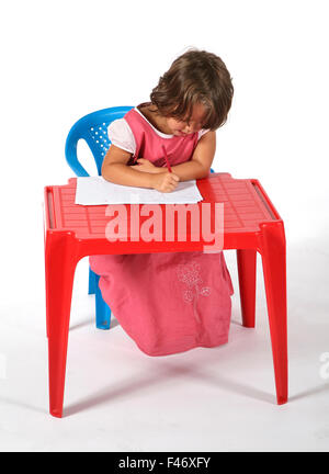 young girl sitted at the desk Stock Photo