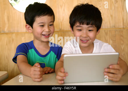 Two boys using digital tablet Stock Photo