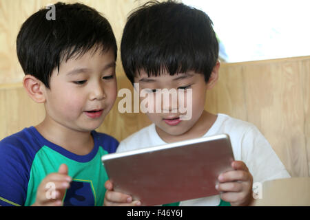 Two boys using digital tablet Stock Photo