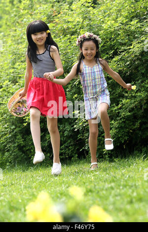 Two girls playing in field Stock Photo