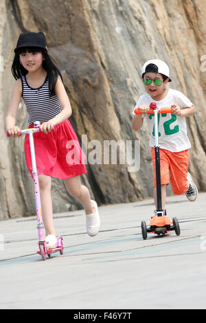 Girls riding scooter Stock Photo