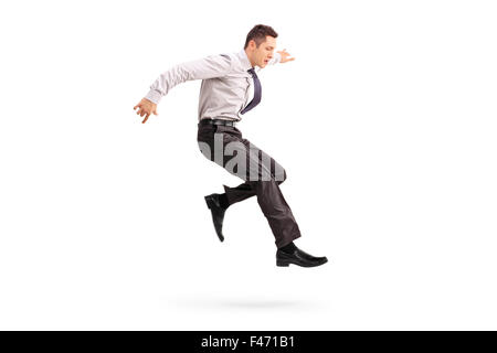 Full length profile shot of a young businessman jumping in the air isolated on white background Stock Photo