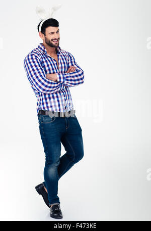 Full length portrait of a man with bunny ears winking at camera isolated on a white background Stock Photo