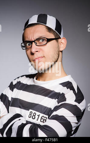 Funny prisoner isolated on gray Stock Photo