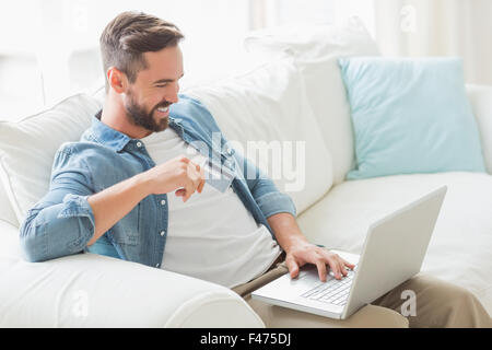 Smiling man working on laptop Stock Photo