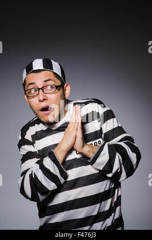 Funny prisoner isolated on gray Stock Photo