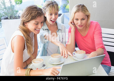Beautiful women using laptop and smiling Stock Photo