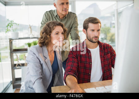 Creative business people using computer on wooden table Stock Photo