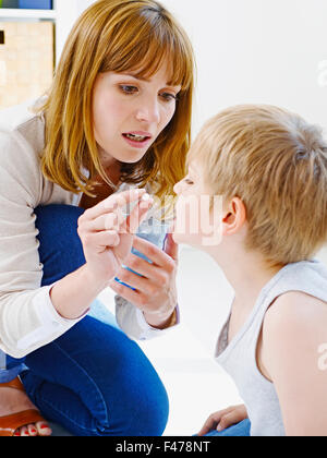 CHILD TAKING MEDICATION Stock Photo