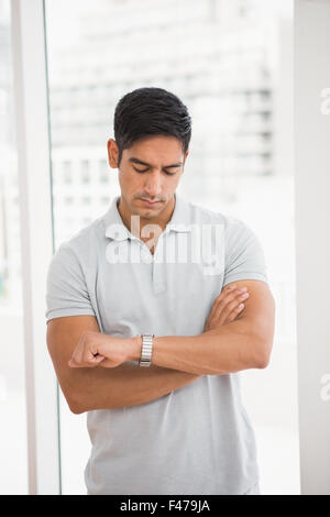 Casual businessman looking at his watch Stock Photo