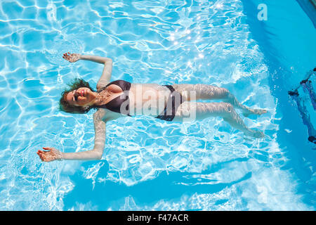 PREGNANT WOMAN IN A POOL Stock Photo