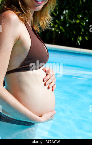 PREGNANT WOMAN IN A POOL Stock Photo