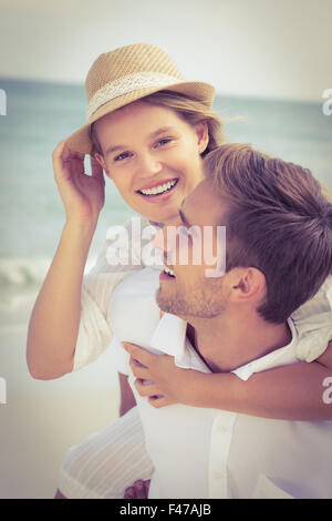 Handsome man giving piggy back to his girlfriend Stock Photo