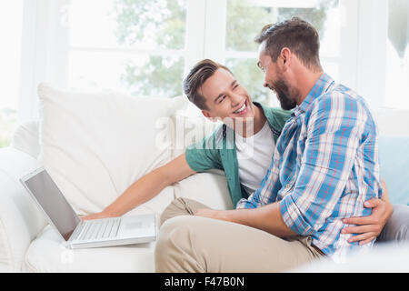 Homosexual couple men discussing over laptop Stock Photo