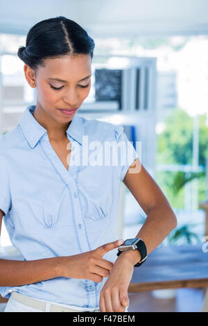 Serious businesswoman using her smart watch Stock Photo