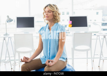 Young businesswoman doing Yoga Stock Photo