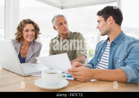 Creative business people using laptop in meeting Stock Photo