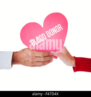Composite image of couple holding heart Stock Photo