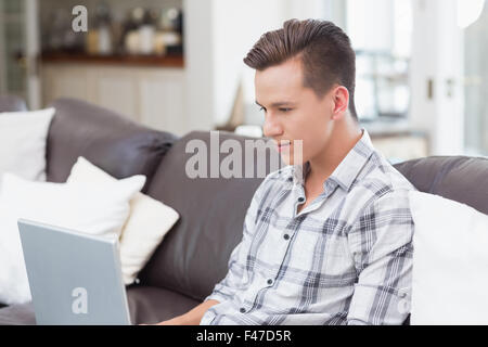 Young handsome man using a laptop Stock Photo