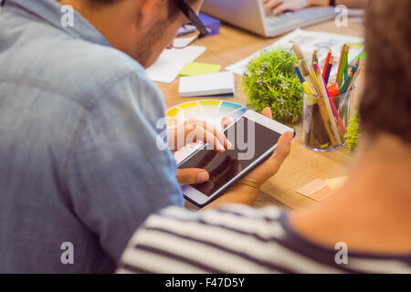 Young man using a tablet during a meeting Stock Photo