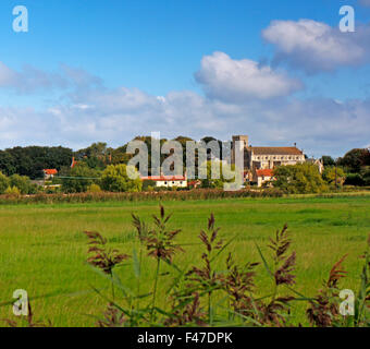 A view across meadows towards the village of Cley-next-the-Sea, Norfolk, England, United Kingdom. Stock Photo