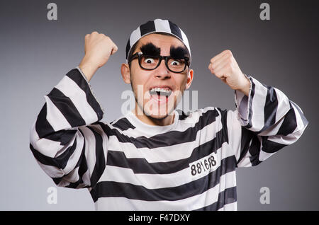 Funny prisoner isolated on gray Stock Photo