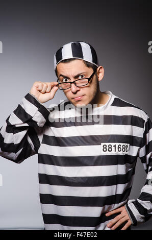 Funny prisoner isolated on gray Stock Photo