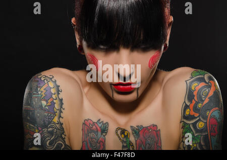 Studio portrait of a young woman with tattooed arms Stock Photo - Alamy