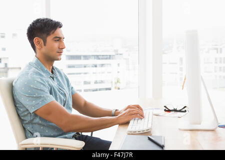 Concentrated casual businessman typing on keyboard Stock Photo