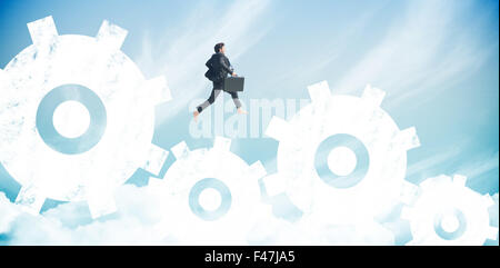 Composite image of businessman jumping Stock Photo