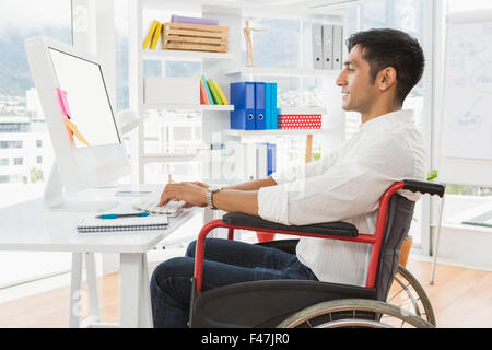 Young smiling businessman in a wheelchair Stock Photo