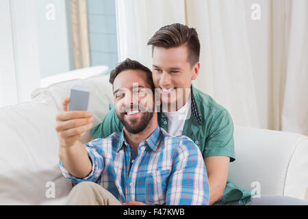 Smiling homosexual couple men taking a selfie Stock Photo
