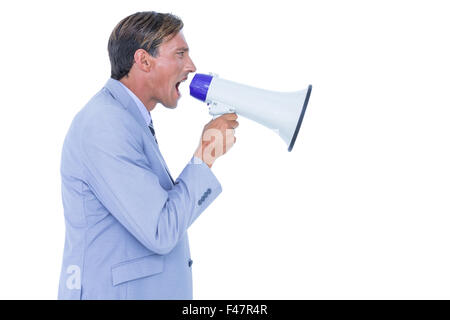 Businessman talking through megaphone Stock Photo